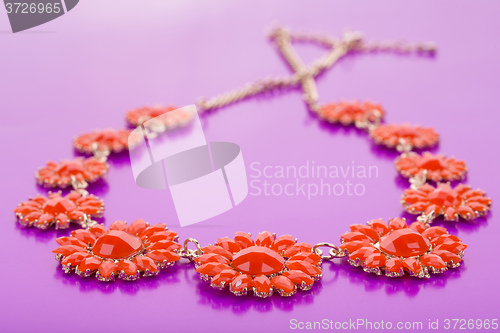 Image of plastic necklace. five beige flower