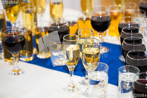 Image of Glasses with champagne on the party table. lot of alcohol