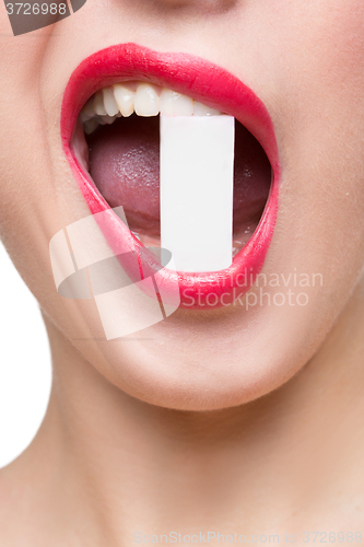 Image of girl holds in teeth white form. isolated
