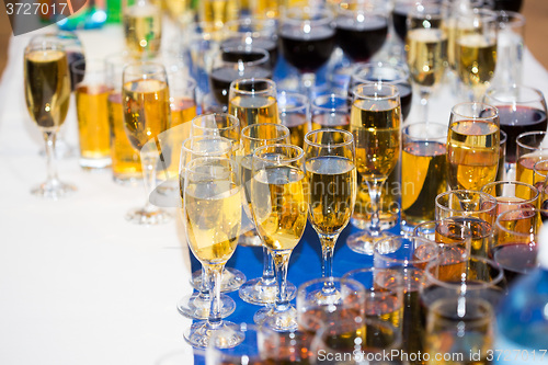 Image of Glasses with champagne on the party table. lot of alcohol