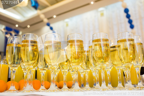 Image of Glasses with champagne on the party table. lot of alcohol