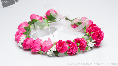 Image of tiara of artificial  roses on a light background