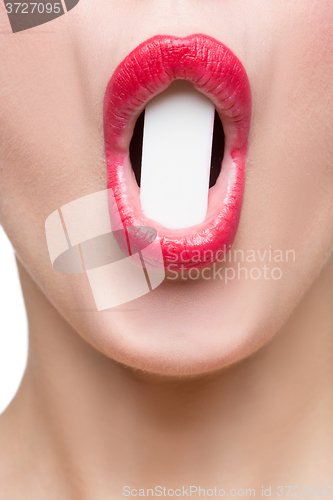 Image of girl holds in teeth white form. isolated