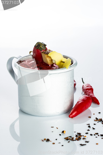 Image of bloody mary cocktail in the iron circle on a white background