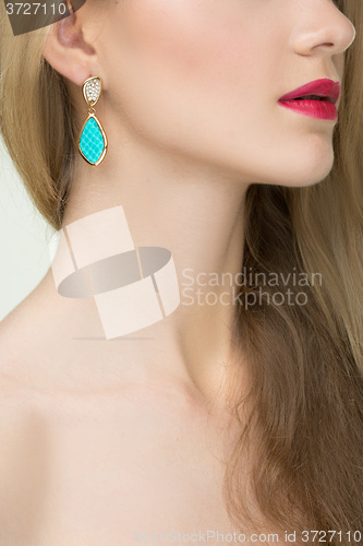 Image of close up of woman wearing shiny diamond earrings