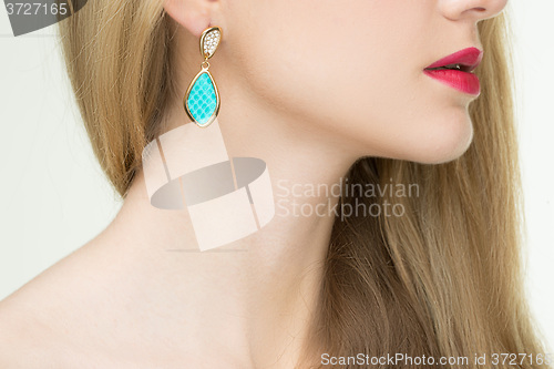 Image of close up of woman wearing shiny diamond earrings