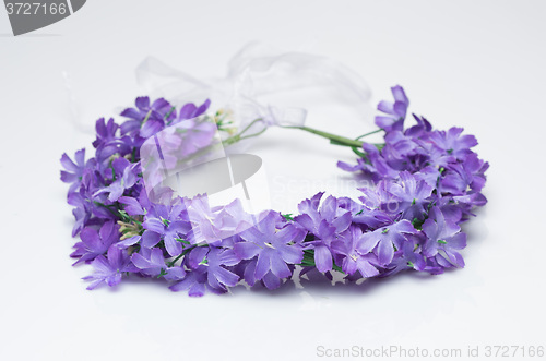 Image of tiara of artificial  roses on a light background