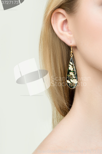 Image of close up of woman wearing shiny diamond earrings