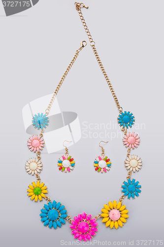 Image of plastic necklace. five beige flower