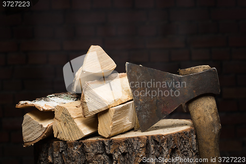 Image of birch firewood, old rusty ax 