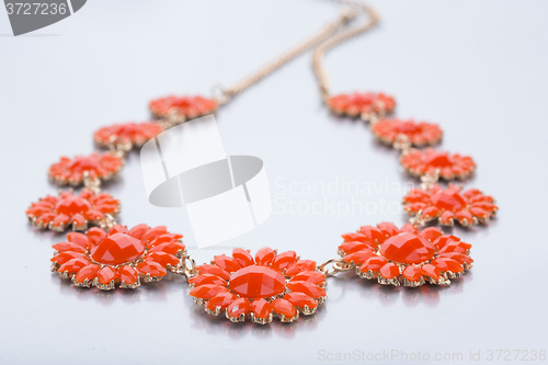 Image of plastic necklace. five beige flower