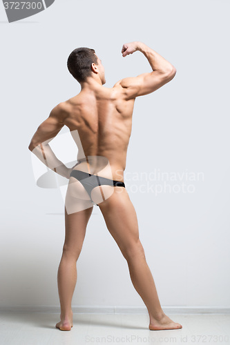 Image of muscular man in a thong