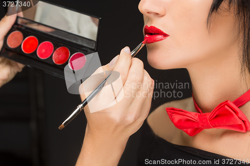 Image of Lips of a girl with artist doing makeup