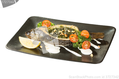 Image of Stuffed seabass on a black plate 