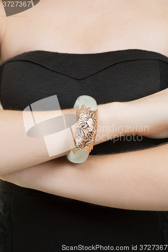 Image of hands close-up of a young girl with leather bracelet