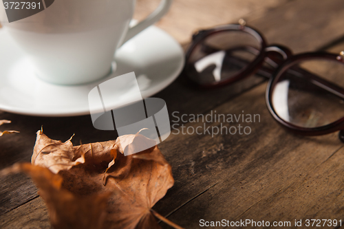 Image of Glasses and cup of coffee on a wooden table