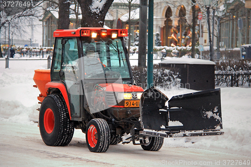 Image of Red Snow Removal Tractor in City