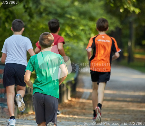 Image of Boys running in park