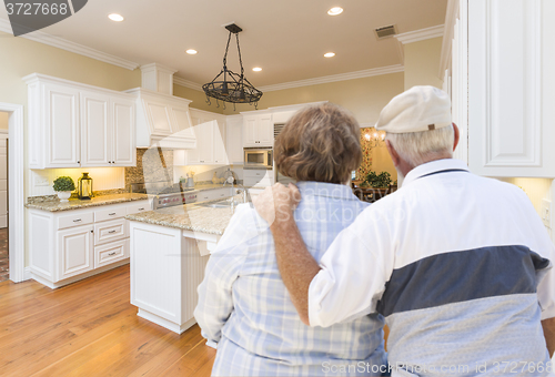 Image of Senior Couple Looking Over Beautiful Custom Kitchen