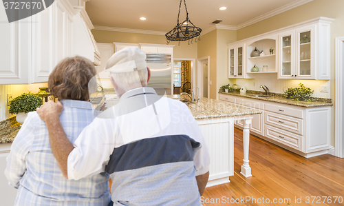 Image of Senior Couple Looking Over Beautiful Custom Kitchen