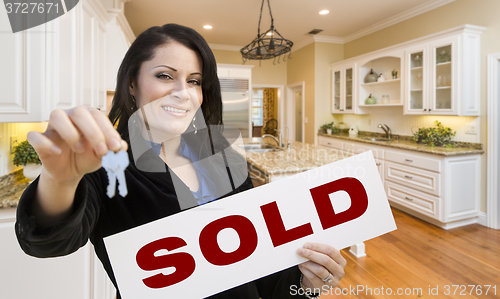 Image of Hispanic Woman In Kitchen Holding House Keys and Sold Sign