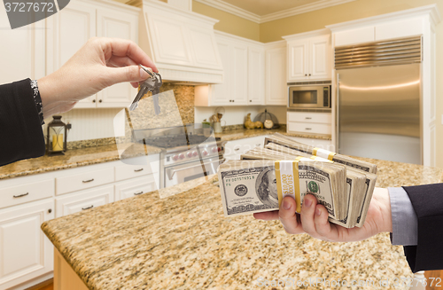 Image of Handing Over Cash for Keys Inside Beautiful Kitchen