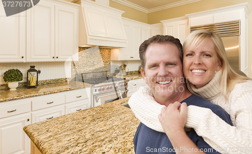 Image of Happy Couple Inside Beautiful Custom Kitchen