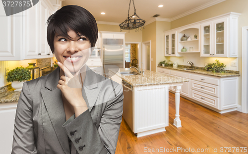 Image of Mixed Race Woman Looking Back Over Shoulder Inside Custom Kitche