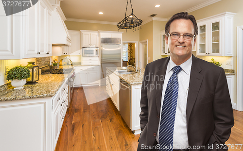 Image of Man Wearing Necktie in Beautiful Custom Residential Kitchen