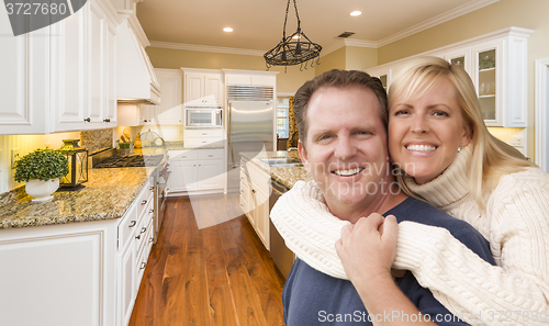 Image of Happy Couple Inside Beautiful Custom Kitchen