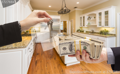 Image of Handing Over Cash for Keys Inside Beautiful Kitchen