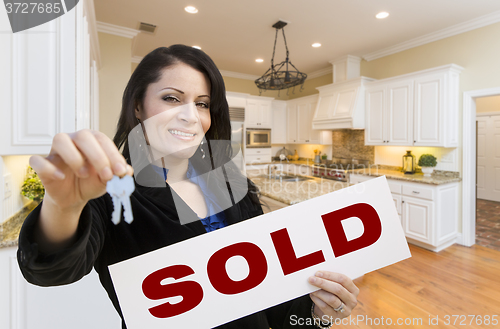 Image of Hispanic Woman In Kitchen Holding House Keys and Sold Sign