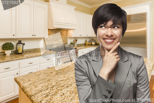 Image of Mixed Race Woman Looking Back Over Shoulder Inside Custom Kitche