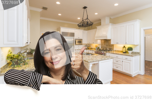 Image of Hispanic Woman with Thumbs Up In Custom Kitchen Interior