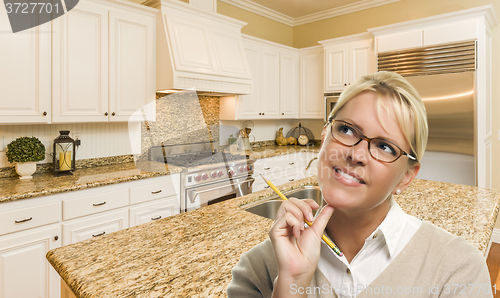 Image of Daydreaming Woman with Pencil Inside Beautiful Custom Kitchen