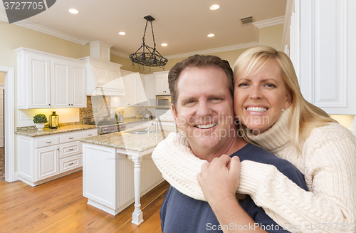 Image of Happy Couple Inside Beautiful Custom Kitchen