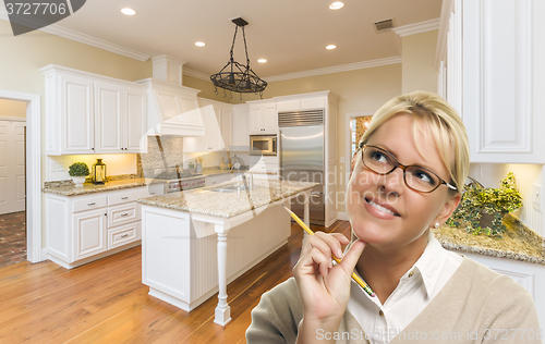 Image of Daydreaming Woman with Pencil Inside Beautiful Custom Kitchen