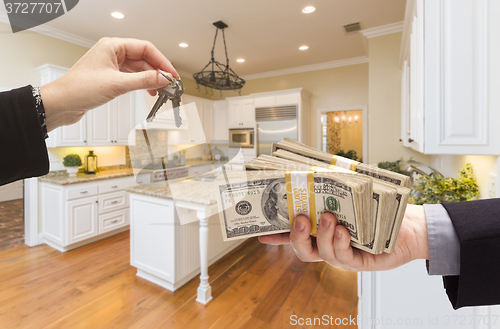 Image of Handing Over Cash for Keys Inside Beautiful Kitchen
