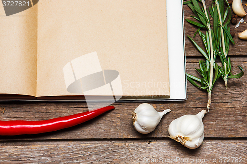 Image of Open blank recipe book on brown wooden background