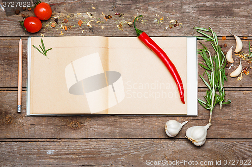 Image of Open blank recipe book on brown wooden background