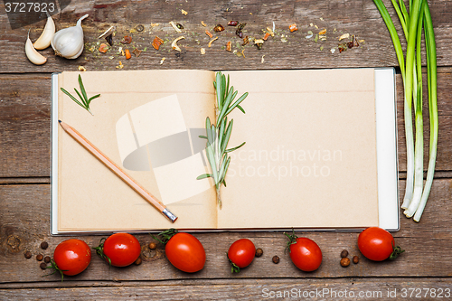 Image of Open blank recipe book on brown wooden background