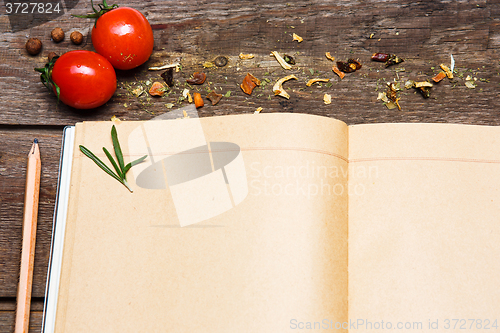 Image of Open blank recipe book on brown wooden background