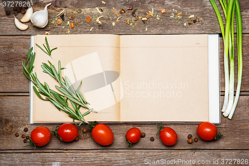 Image of Open blank recipe book on brown wooden background