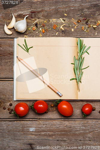 Image of Open blank recipe book on brown wooden background