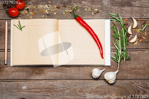 Image of Open blank recipe book on brown wooden background