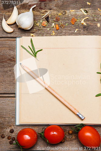 Image of Open blank recipe book on brown wooden background