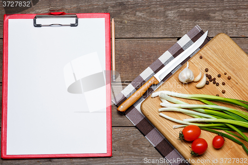 Image of Open blank recipe book on brown wooden background