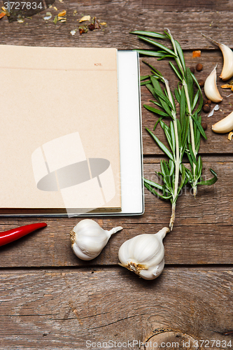 Image of Open blank recipe book on brown wooden background