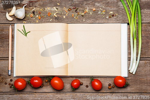 Image of Open blank recipe book on brown wooden background