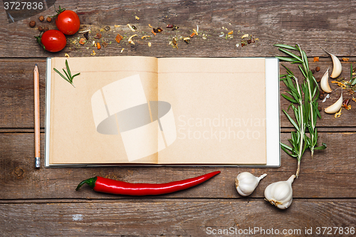 Image of Open blank recipe book on brown wooden background